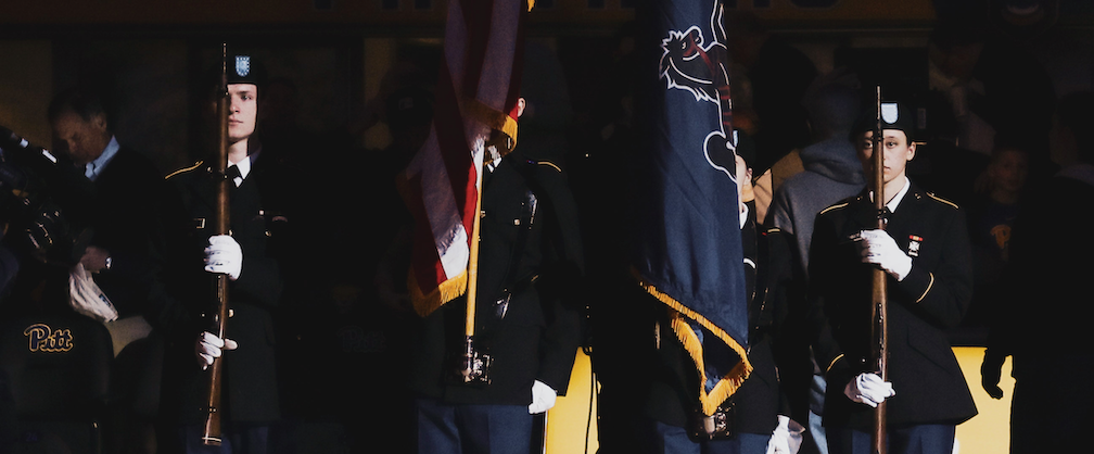 Cadets stand at attention, at a Pitt Basketball game, in which they serve as the color guard for.