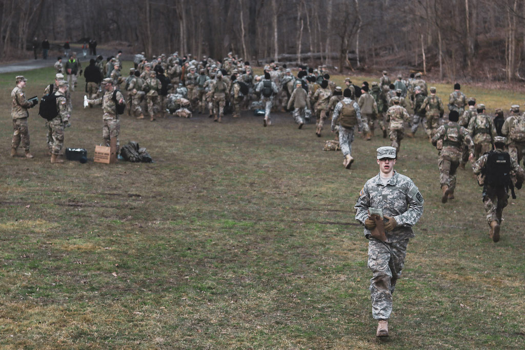 A cadet runs towards the camera at a platoon tactics lab.