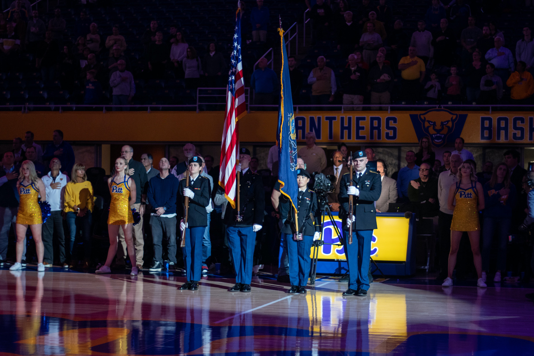 Cadets are the color guard at a Pitt basketball game.
