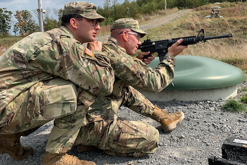 A cadet shoots an M4 at the qualification range.